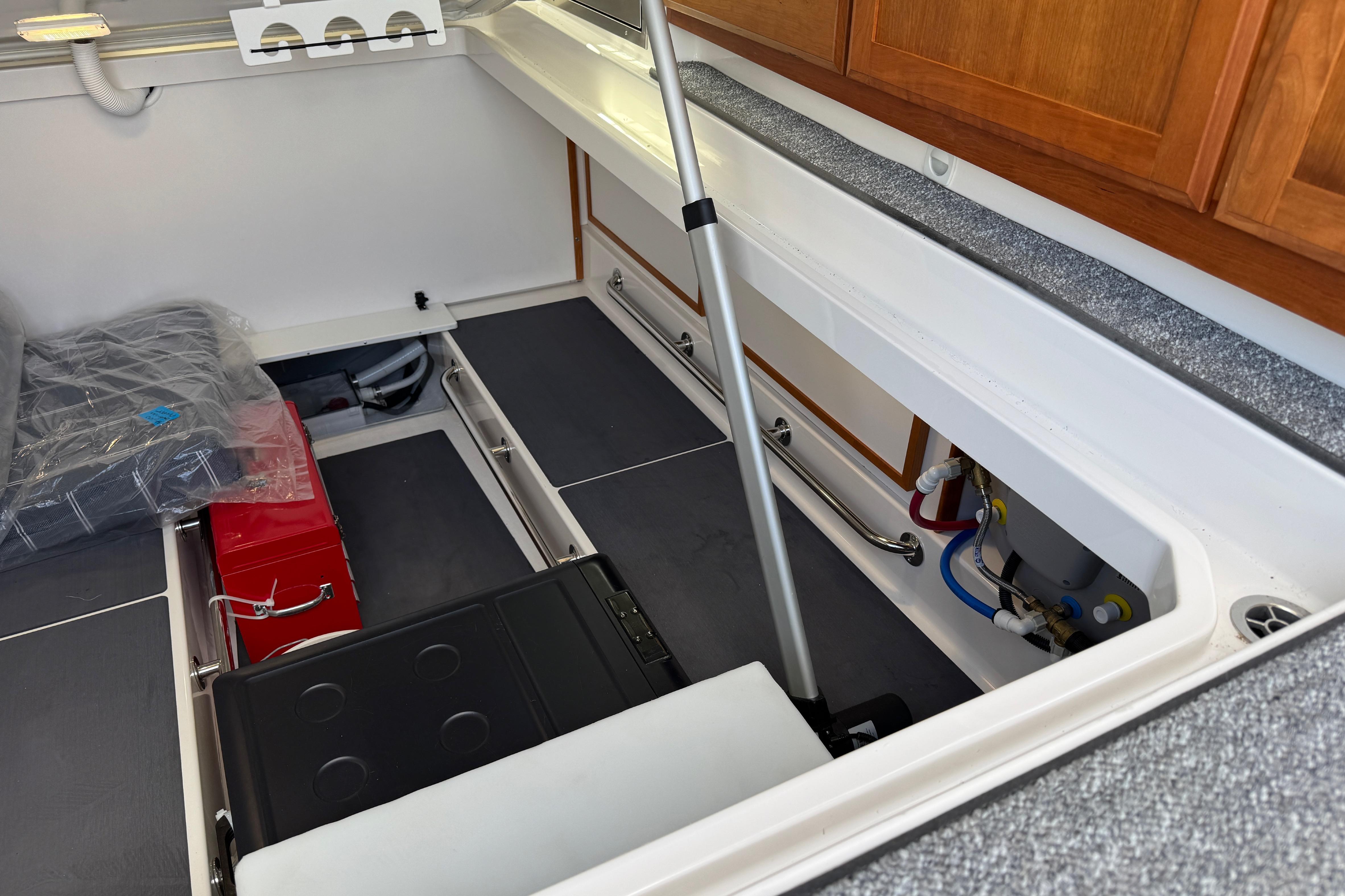 2025 Back Cove 34O boat interior storage compartment with equipment and cabinetry.