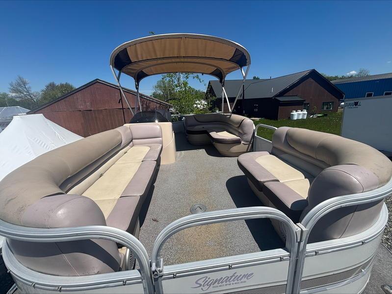 2015 Sun Tracker PARTY BARGE® 22 DLX pontoon boat with spacious seating and canopy.