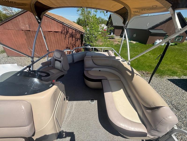 2015 Sun Tracker PARTY BARGE® 22 DLX pontoon boat with spacious seating and canopy.