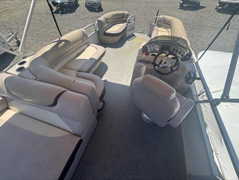 2015 Sun Tracker PARTY BARGE® 22 DLX interior with beige seating and steering console.