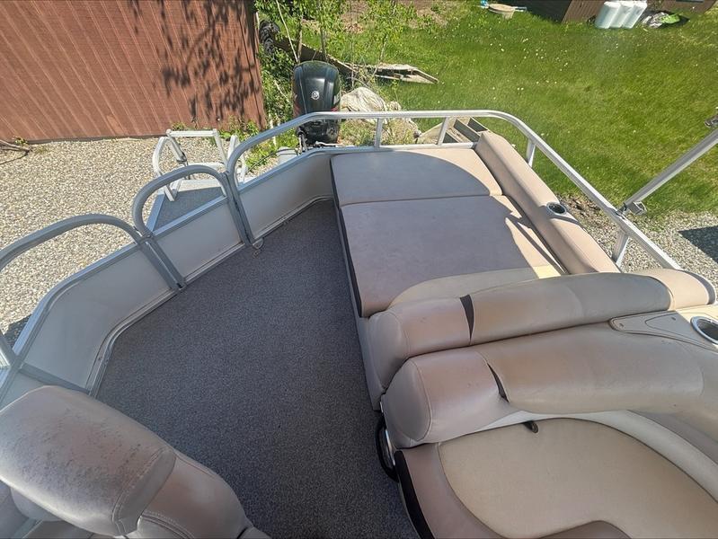 2015 Sun Tracker PARTY BARGE® 22 DLX interior with beige seating and railing.