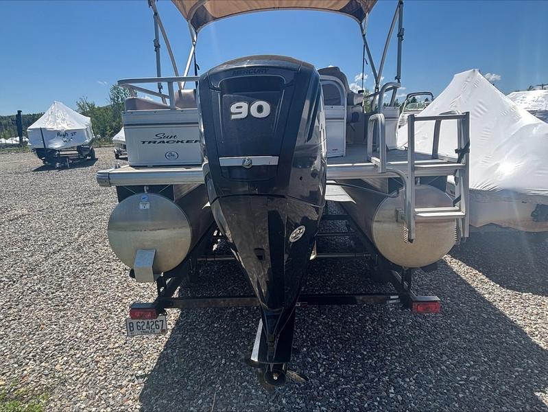 2015 Sun Tracker PARTY BARGE® 22 DLX with 90 HP engine, parked on gravel.
