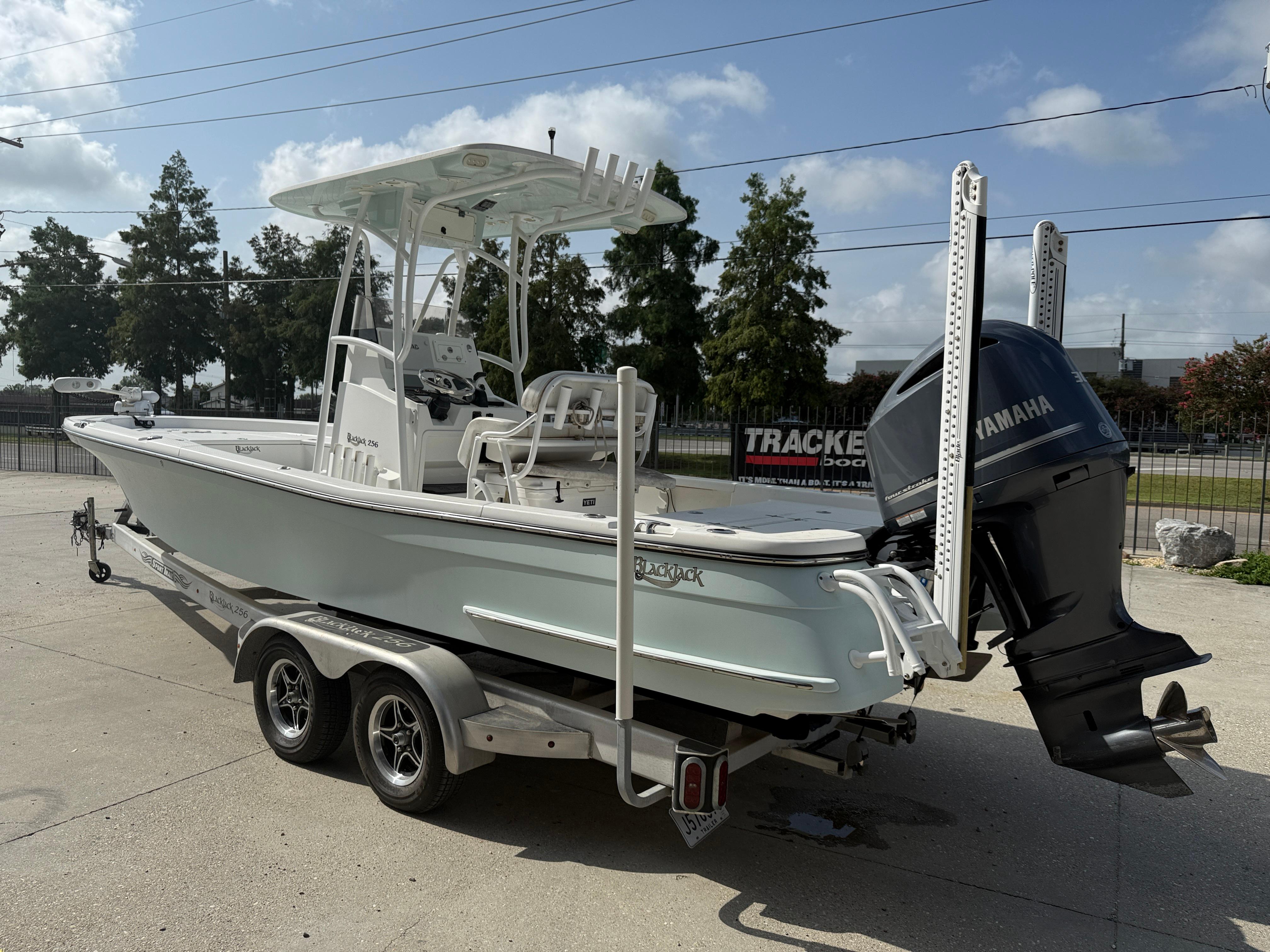 2018 BlackJack 256 boat on trailer with Yamaha outboard motor, parked outdoors.