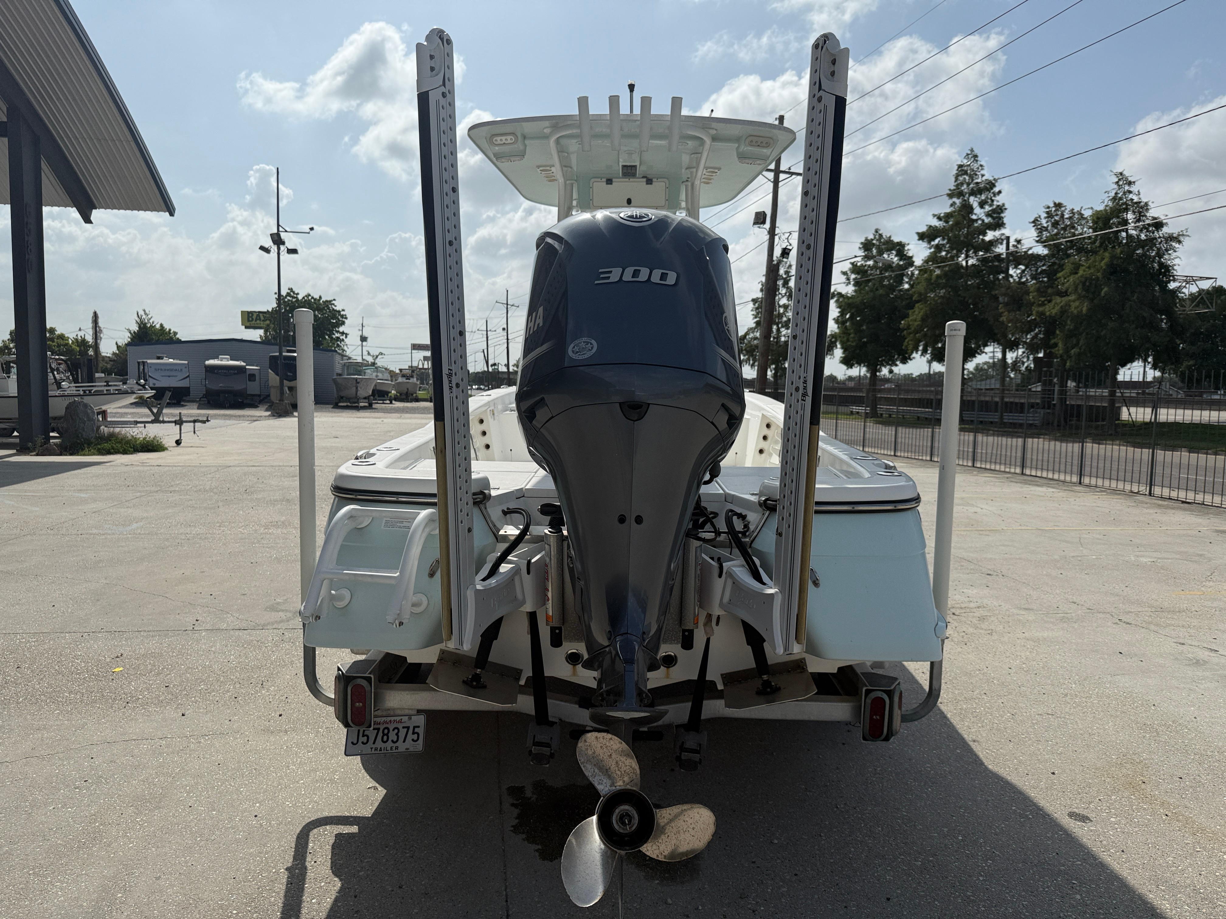 2018 BlackJack 256 boat with Yamaha 300 engine, parked outdoors on a sunny day.