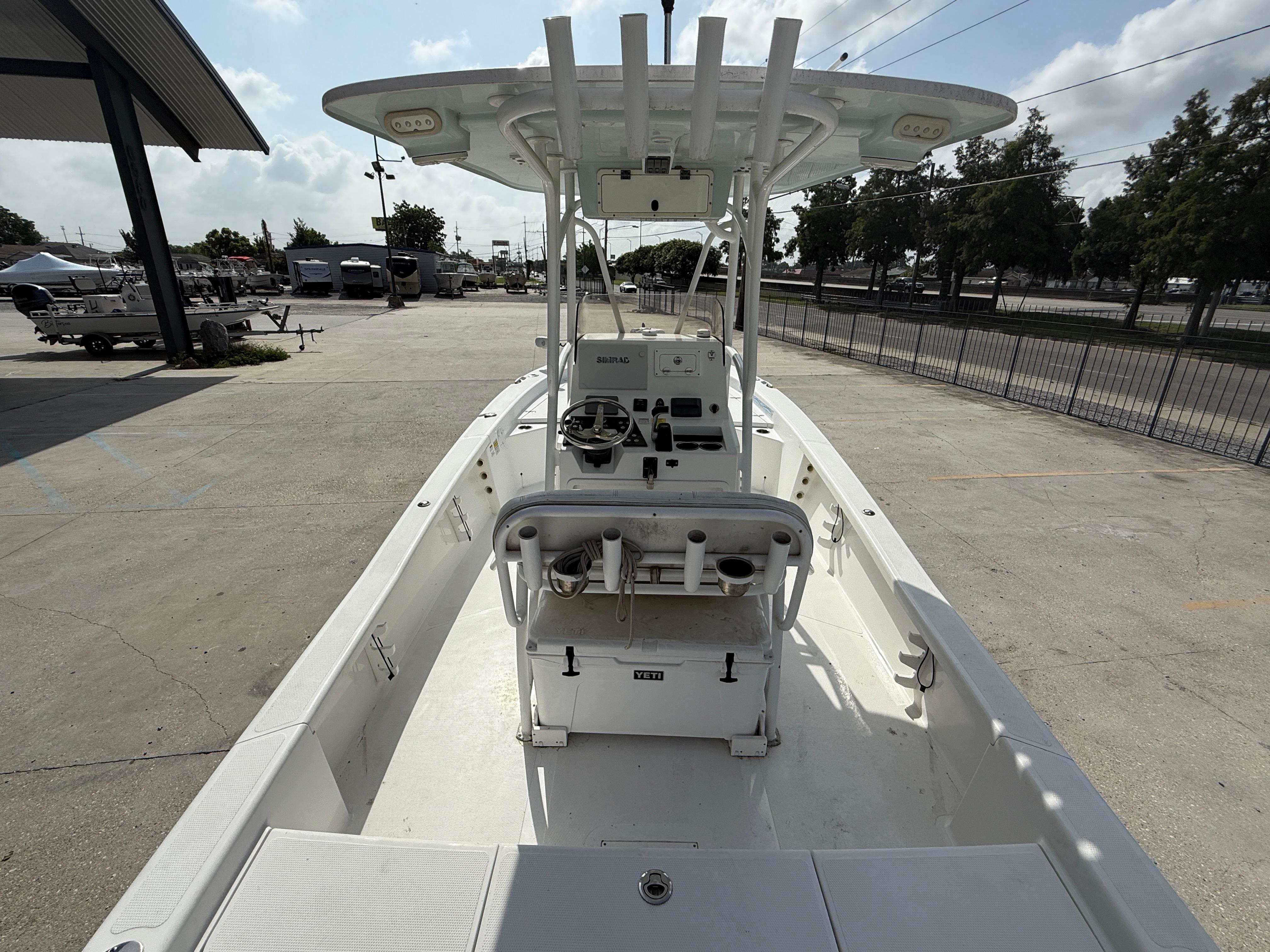2018 BlackJack 256 boat with center console, parked outdoors on a sunny day.