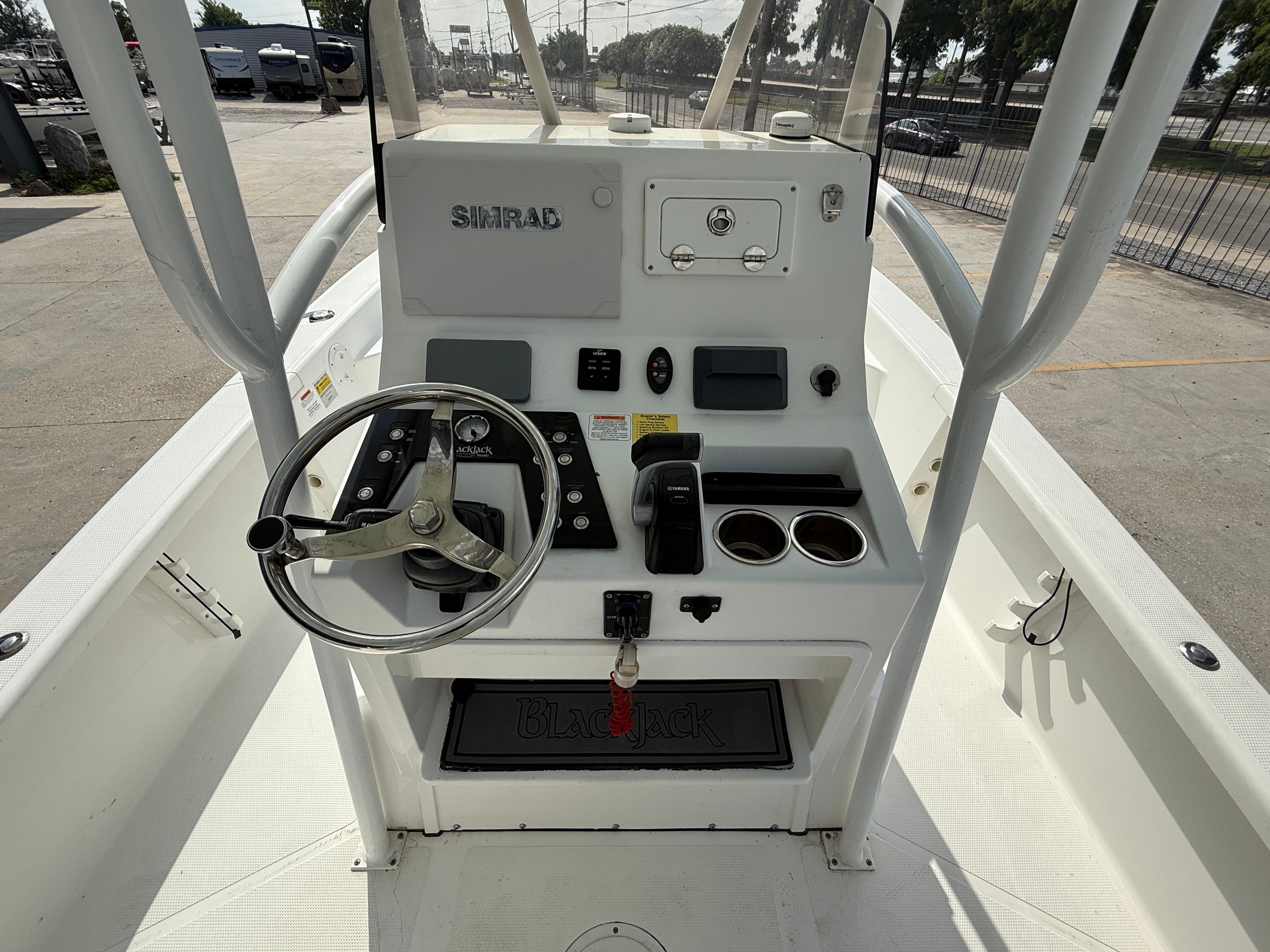 2018 BlackJack 256 boat console with steering wheel and Simrad electronics.