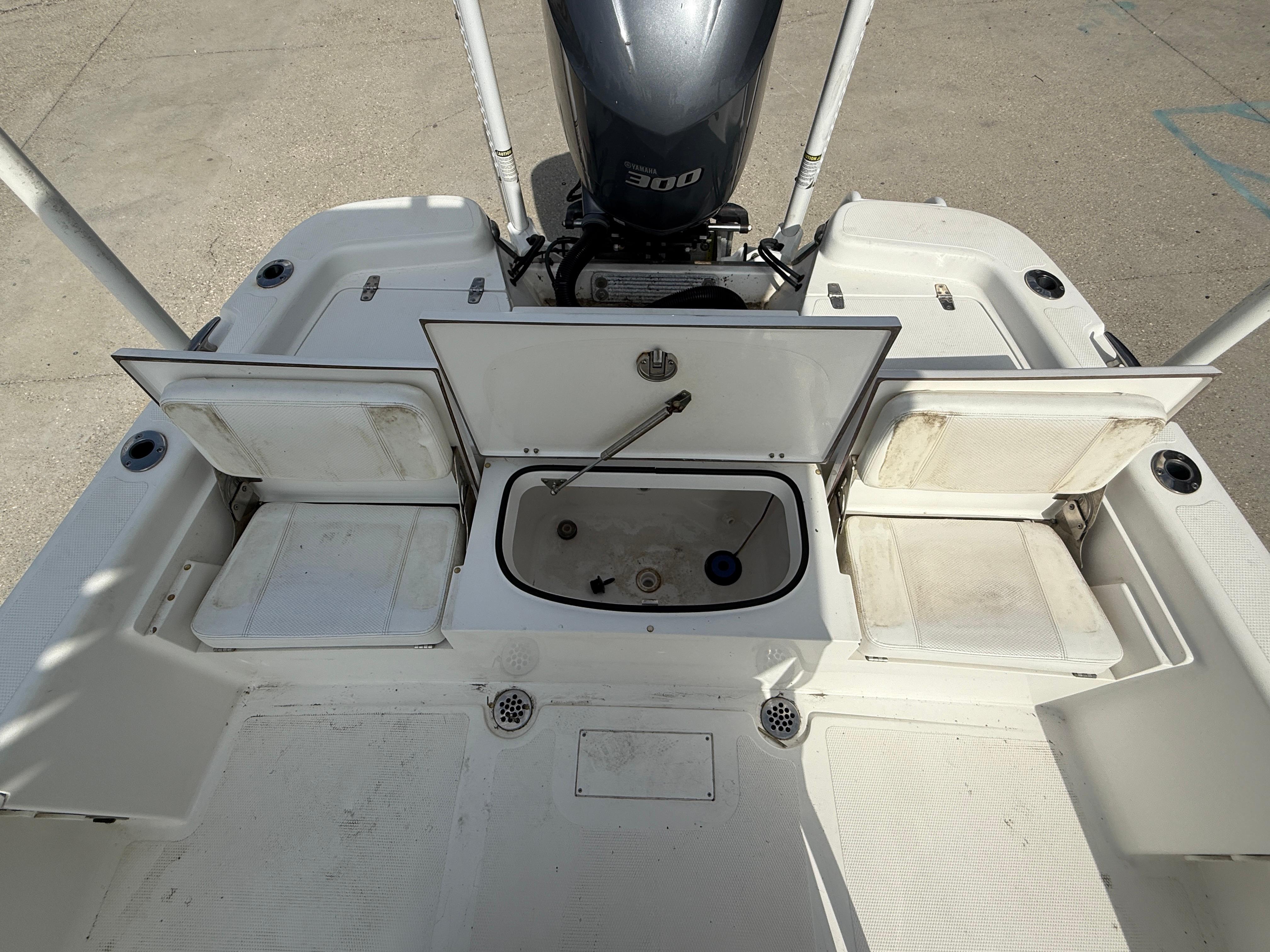 2018 BlackJack 256 boat deck with open storage compartments and Yamaha 300 engine.