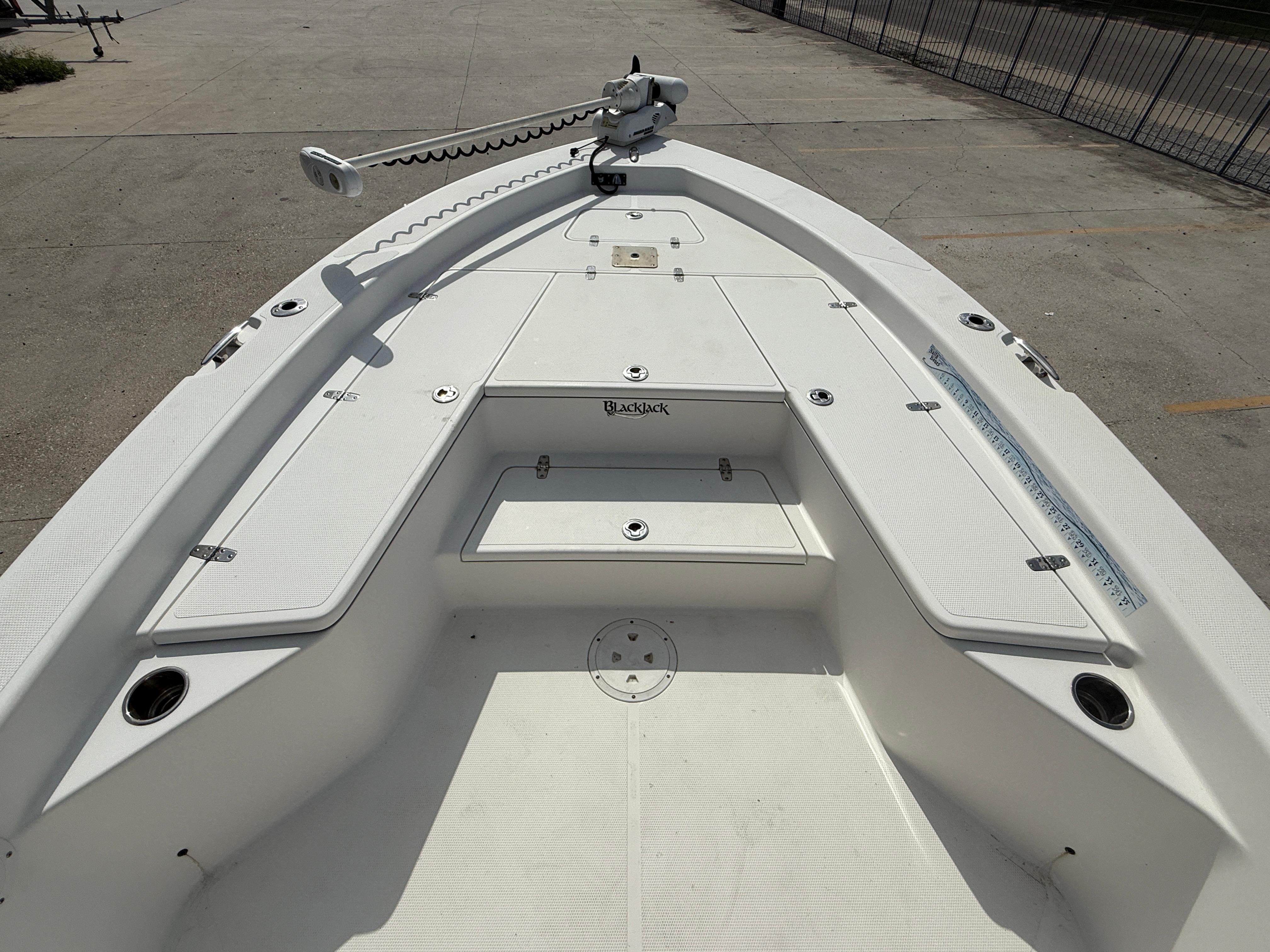 2018 BlackJack 256 boat deck with storage compartments and trolling motor.