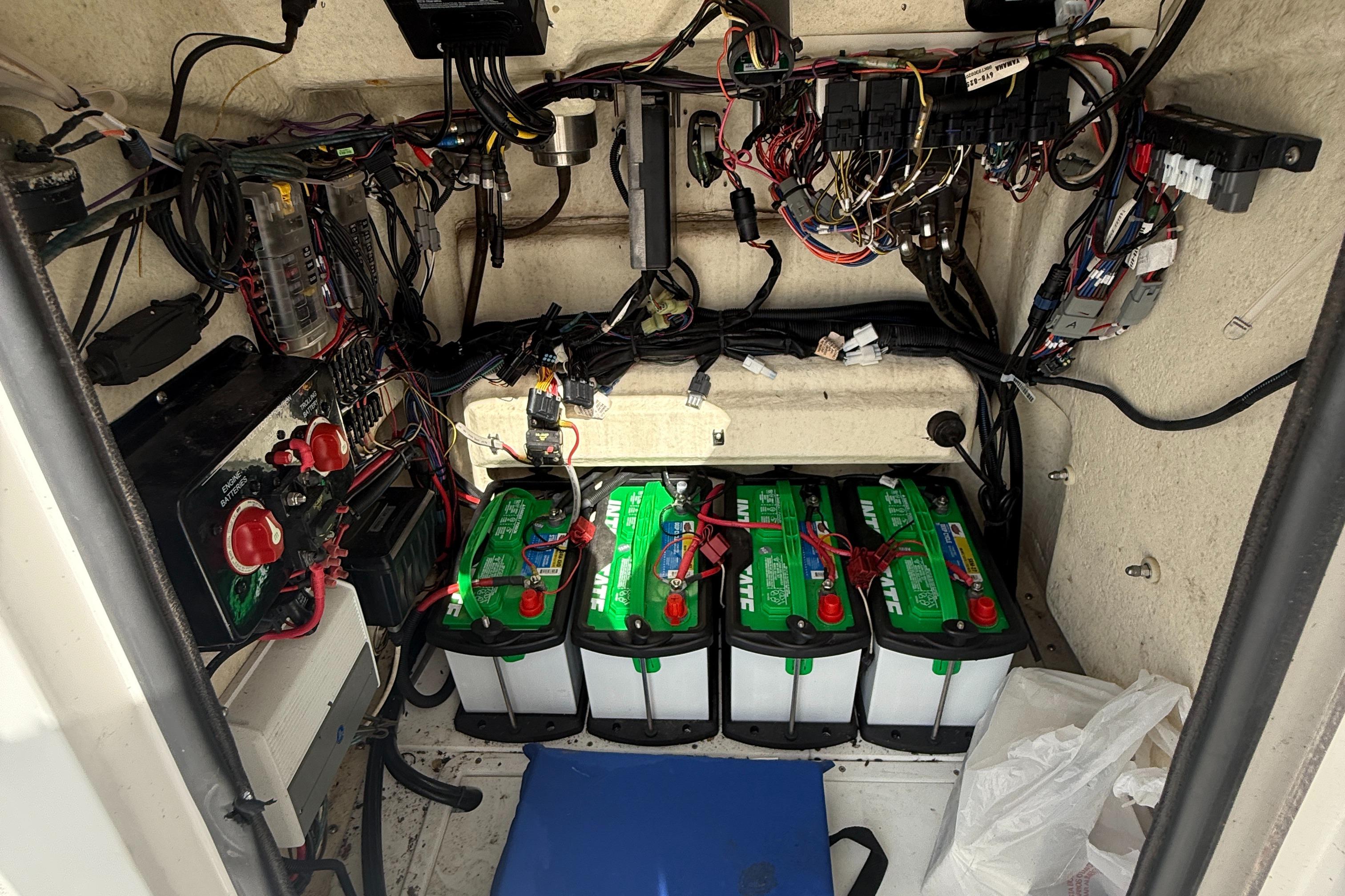 Electrical compartment of a 2018 BlackJack 256 boat with batteries and wiring.