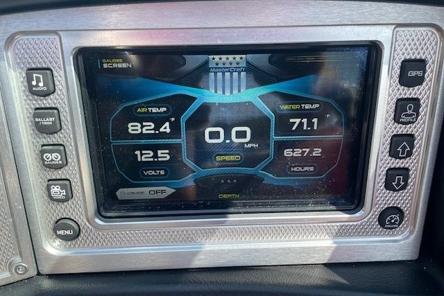 Dashboard of a 2013 MasterCraft X-25 boat displaying air and water temperatures.