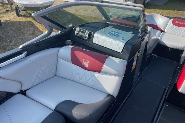 2013 MasterCraft X-25 boat interior with white and red seating, showcasing luxury design.