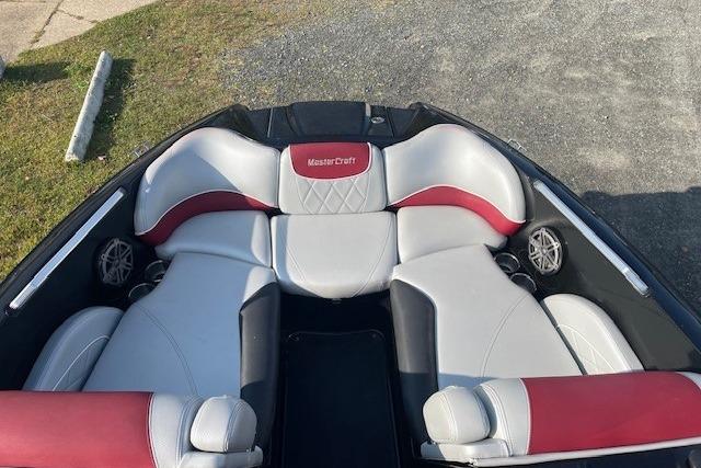 2013 MasterCraft X-25 boat interior with red and gray seating.