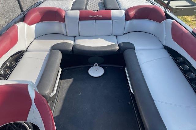 2013 MasterCraft X-25 boat interior with red and white seating.