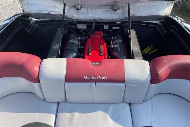 2013 MasterCraft X-25 boat engine with red and white seating.