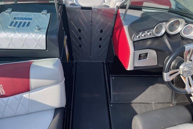 2013 MasterCraft X-25 boat interior with red and white seating, modern dashboard, and steering wheel.