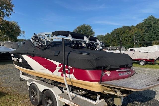 2013 MasterCraft X-25 boat on trailer, covered, outdoors.