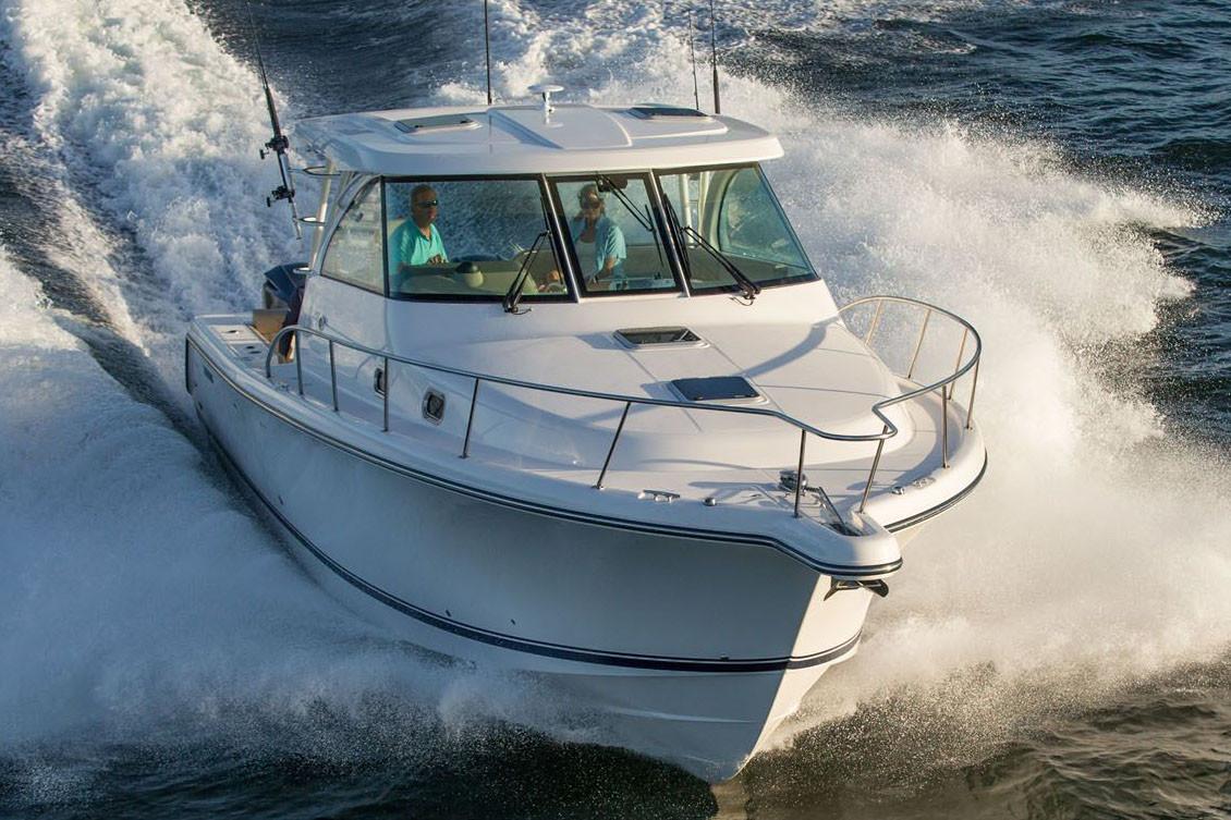 Manufacturer Provided Image: 2019 Pursuit OS 385 Offshore boat cruising on water.