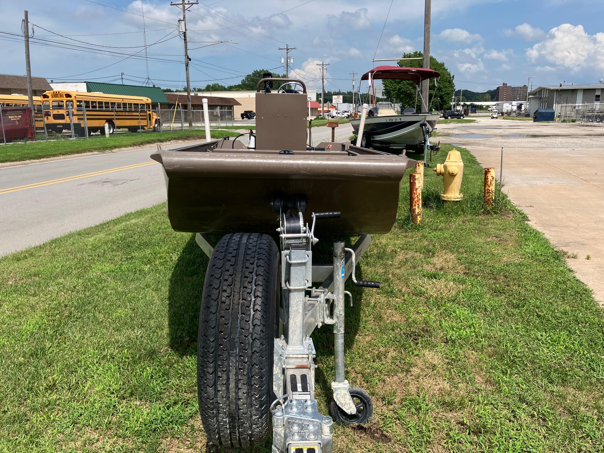 2017 Pro-Drive SBX Series 18' boat on trailer, parked on grass beside a road.
