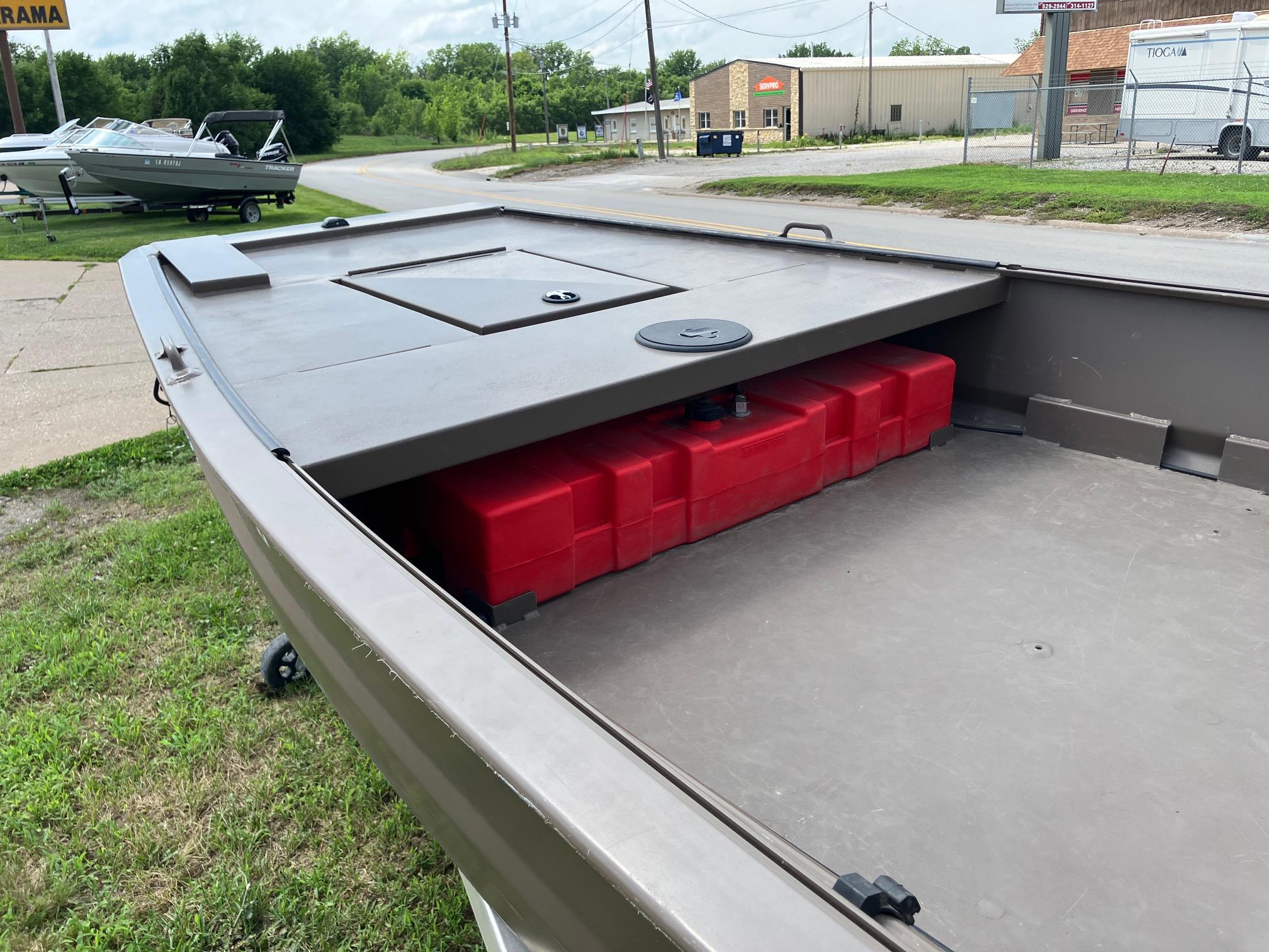 2017 Pro-Drive SBX Series 18' boat with red storage compartment, parked outdoors.