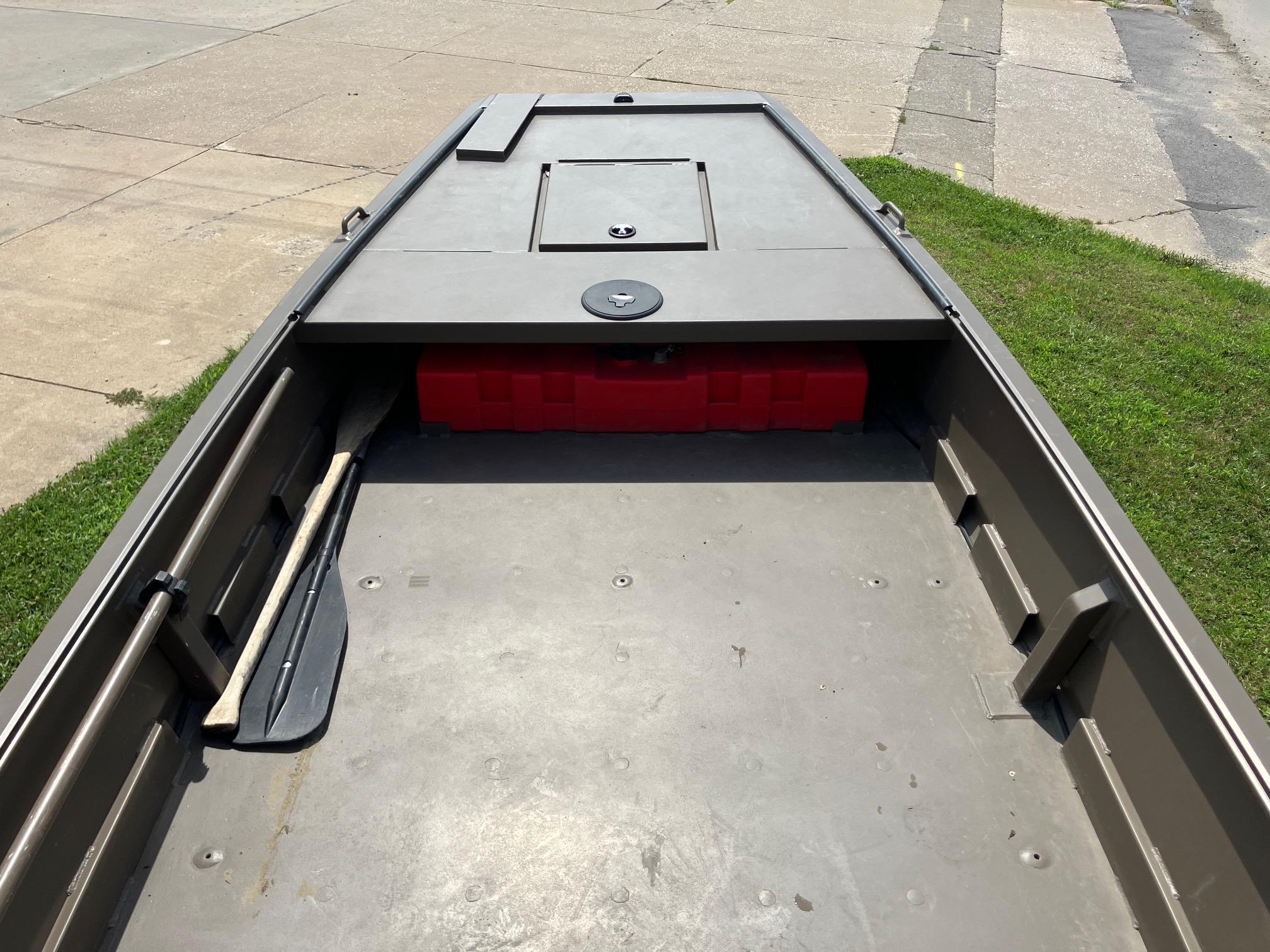 2017 Pro-Drive SBX Series 18' boat interior with storage compartment and paddle.