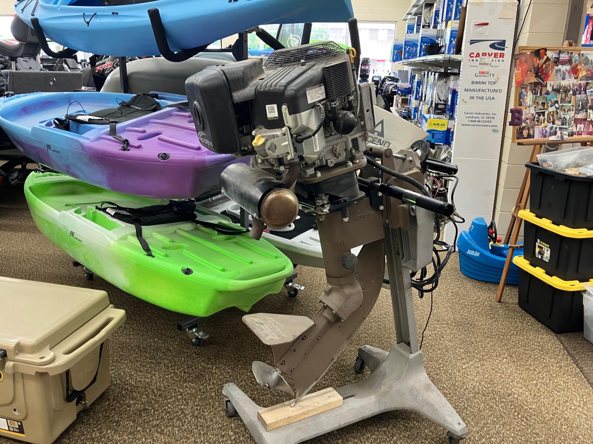 2017 Pro-Drive SBX Series 18' motor displayed in a store with colorful kayaks.