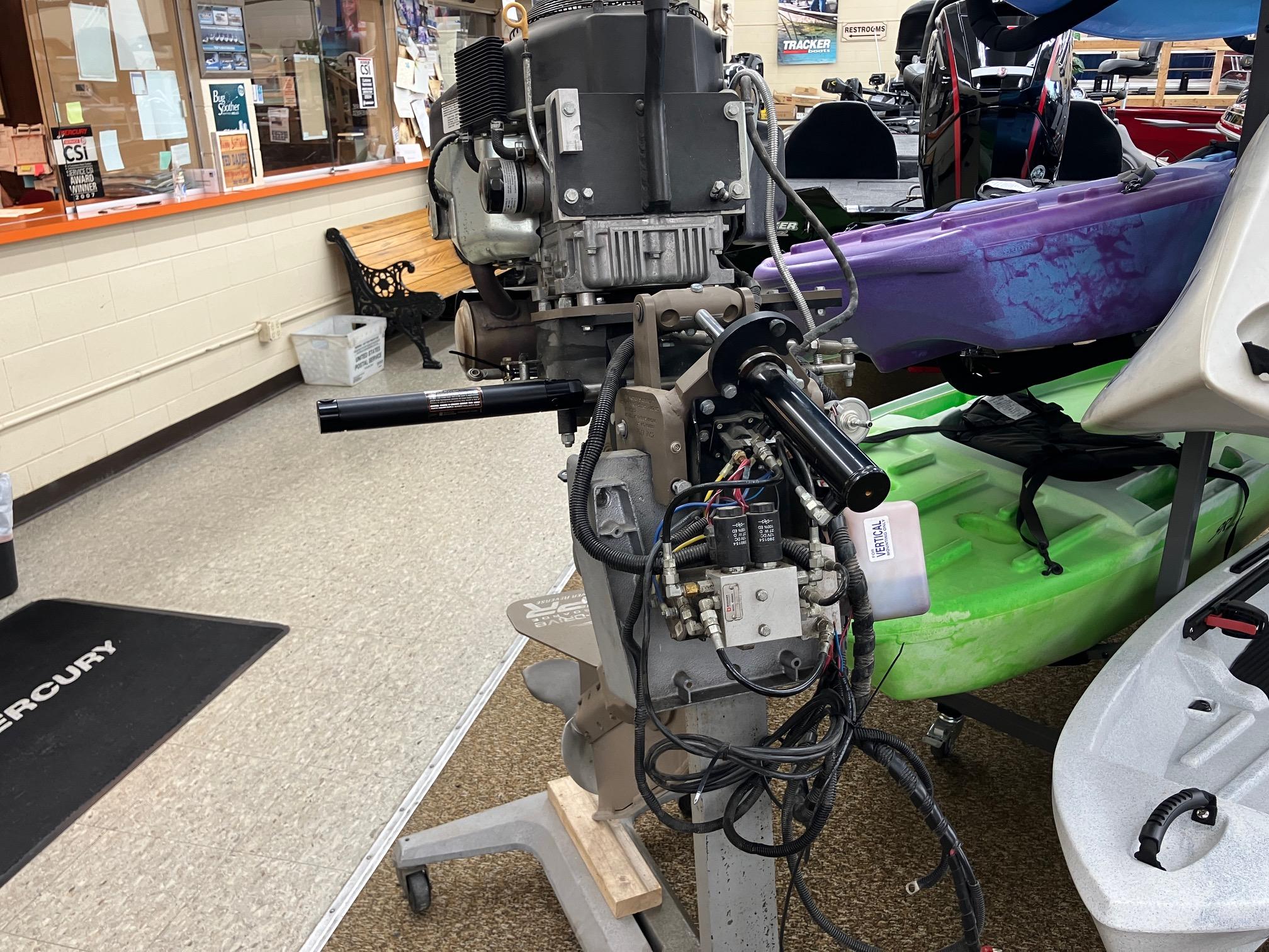 2017 Pro-Drive SBX Series 18' boat motor in a showroom with kayaks.