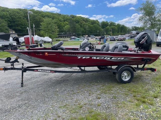 2023 Tracker Pro Team 175 TXW boat on trailer, parked outdoors under blue sky.