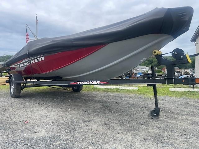 2023 Tracker Pro Team 175 TXW boat on trailer, covered, parked outdoors.