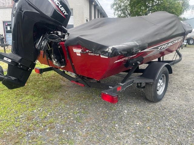 2023 Tracker Pro Team 175 TXW boat with cover, on trailer, parked outdoors.