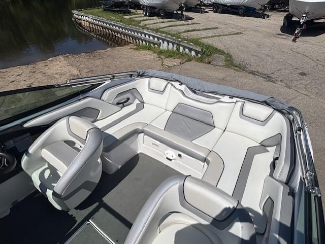 2017 Yamaha Boats SX190 interior with gray and white seating, docked near a lake.