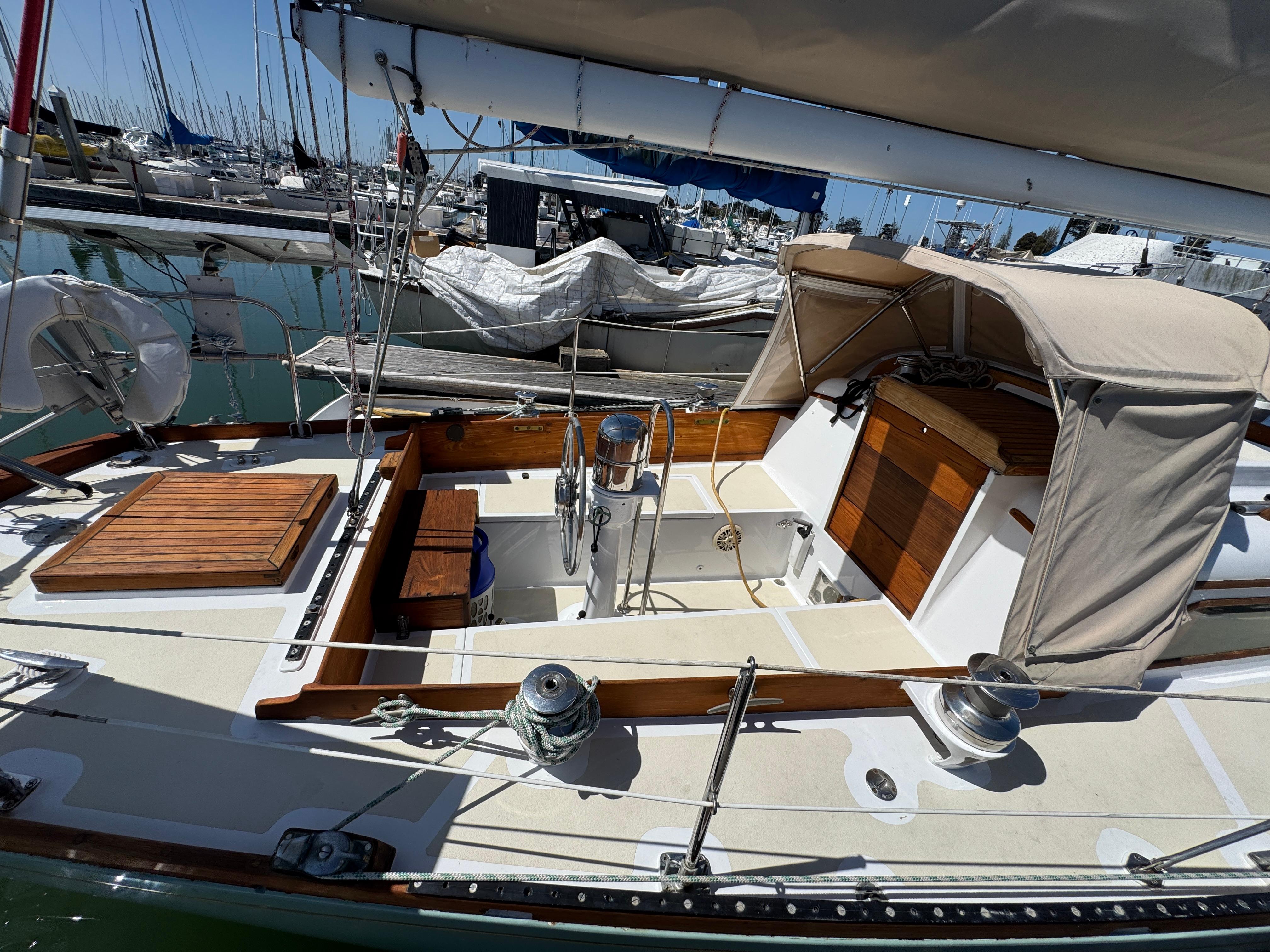 1970 Cheoy Lee Luders 36 sailboat with wooden accents docked in a marina.