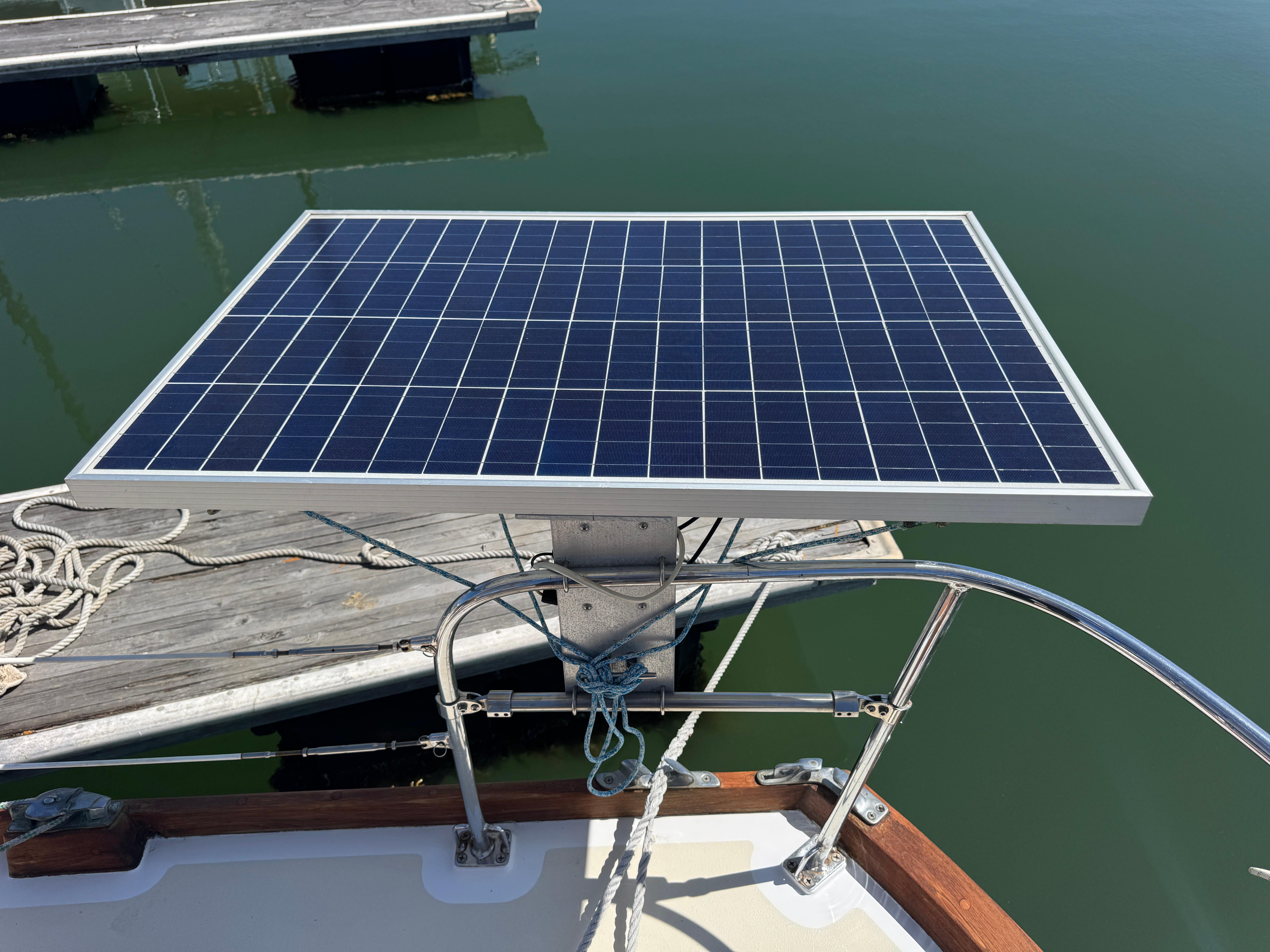 Solar panel on 1970 Cheoy Lee Luders 36 yacht, docked by calm water.