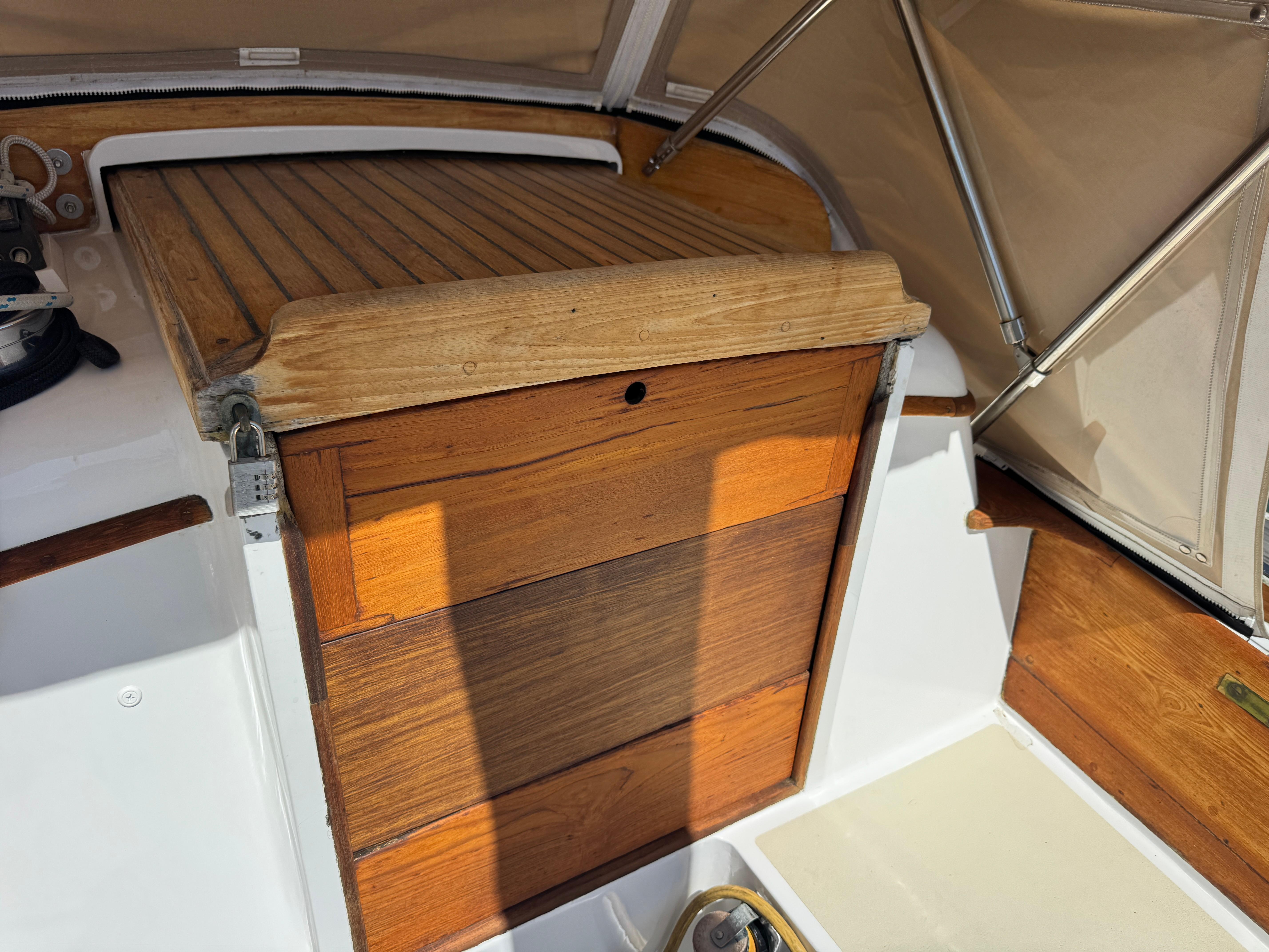 1970 Cheoy Lee Luders 36 sailboat cockpit with wooden hatch and beige canopy.