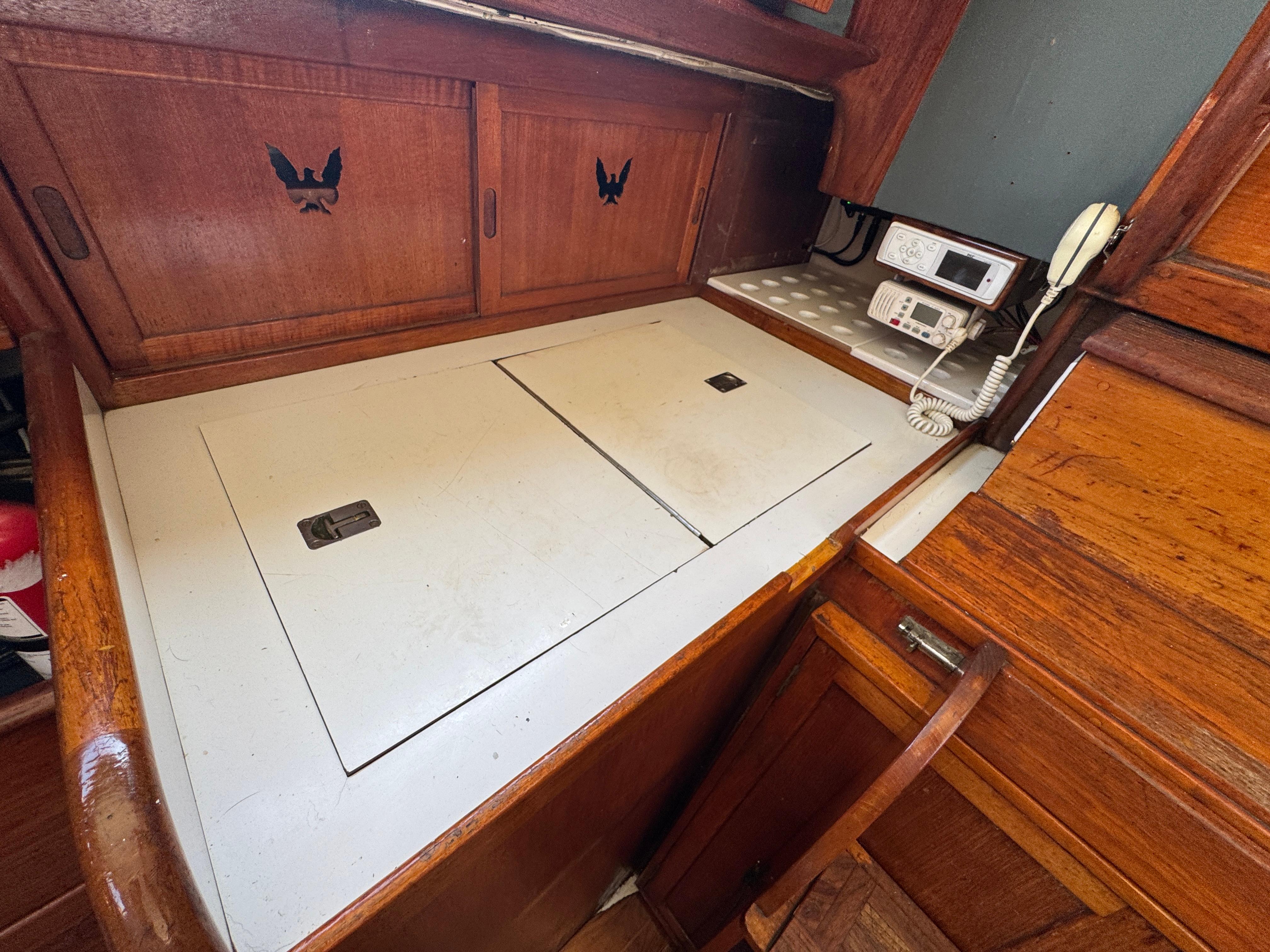 1970 Cheoy Lee Luders 36 yacht interior with wooden cabinetry and navigation equipment.