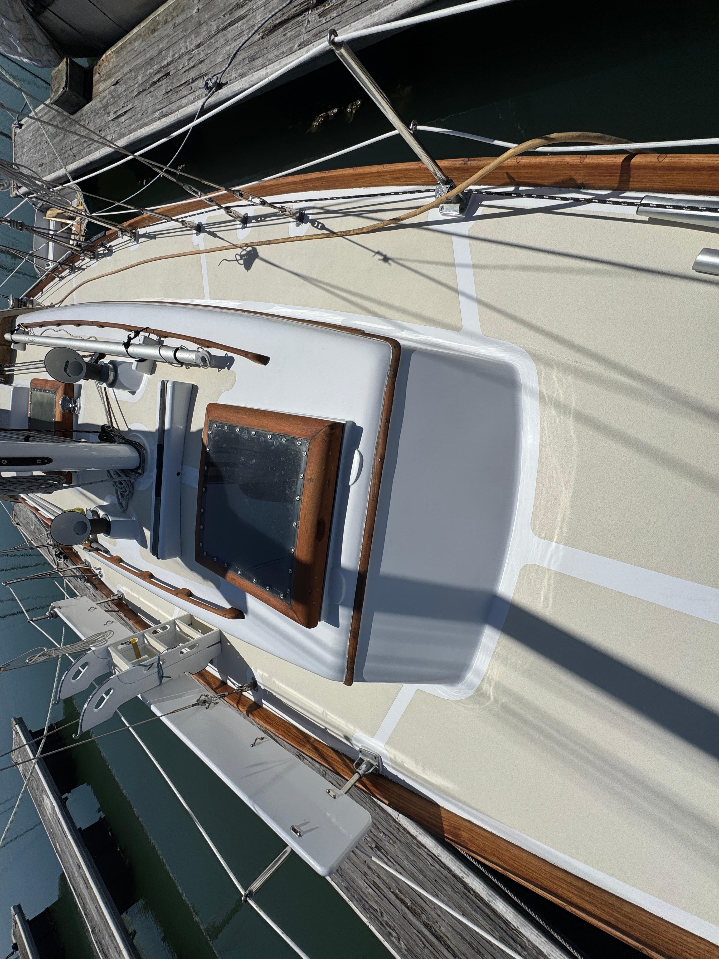 1970 Cheoy Lee Luders 36 sailboat deck with wooden trim, docked at marina.