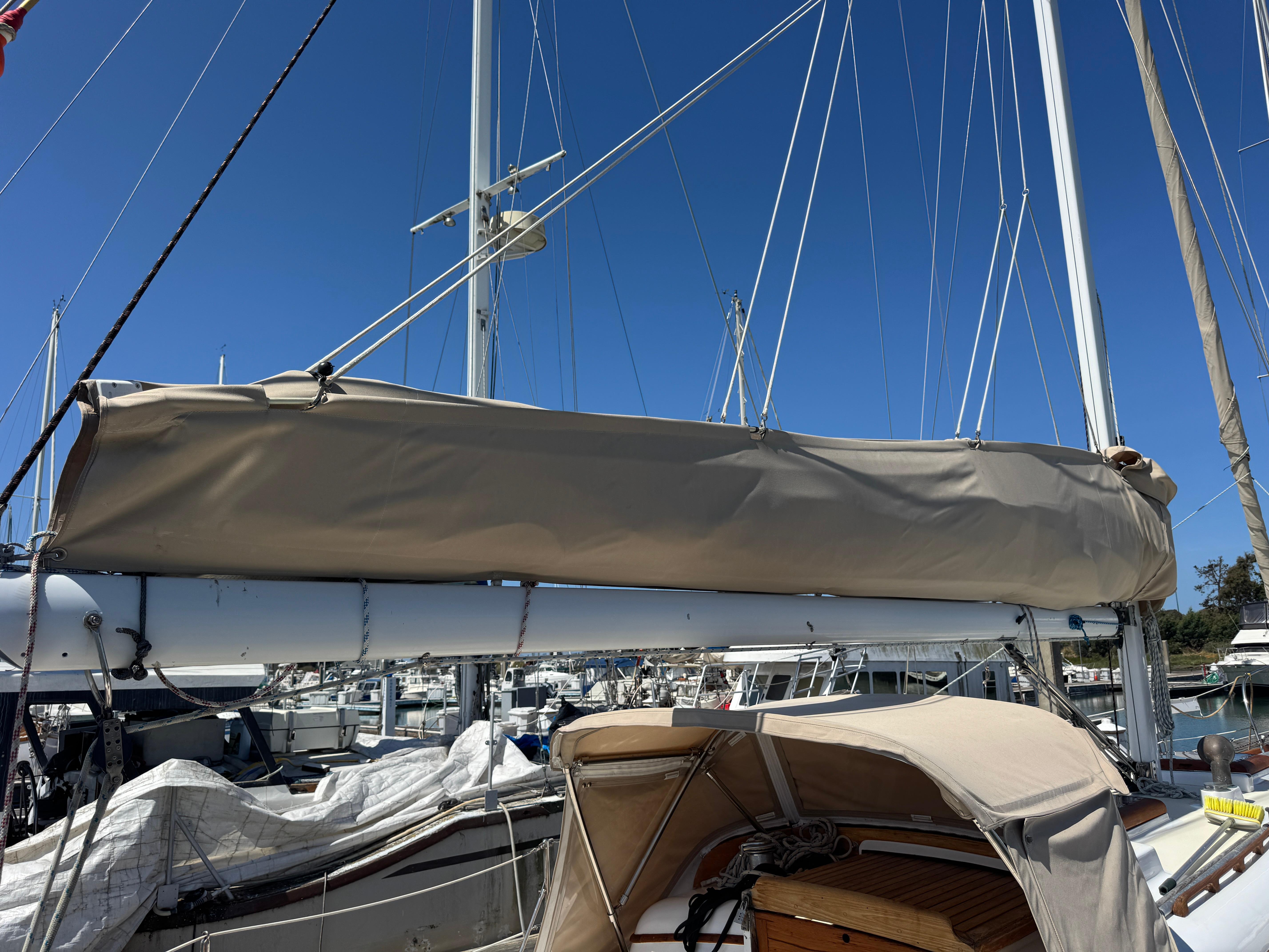 1970 Cheoy Lee Luders 36 sailboat with covered boom, docked in marina.