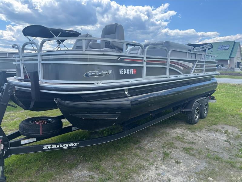 2022 Ranger 220 F pontoon boat on trailer, parked on grass under a cloudy sky.