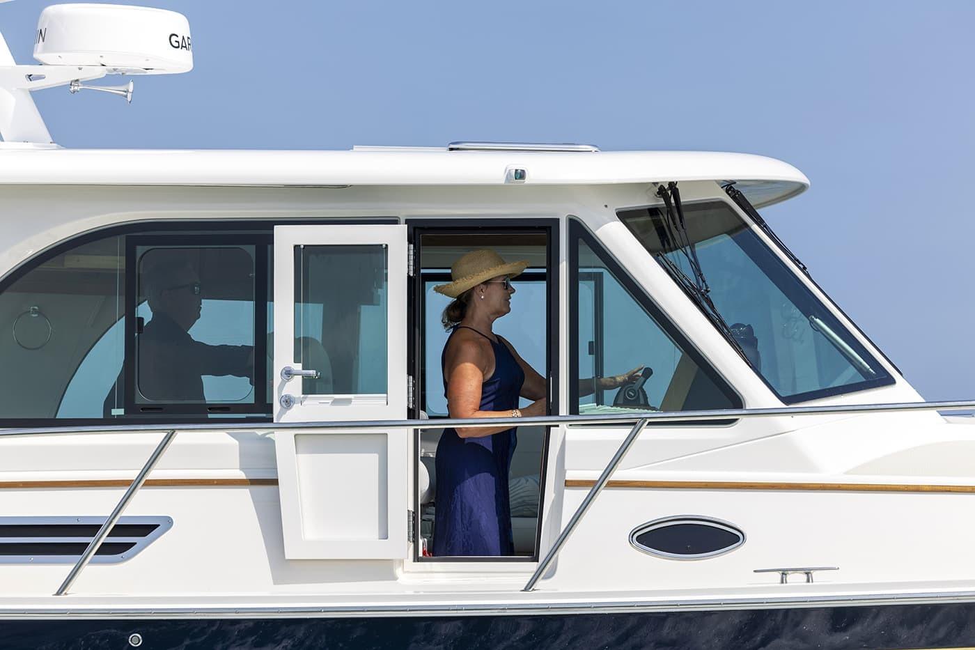 2026 Back Cove 412 yacht with passengers, cruising on a sunny day.