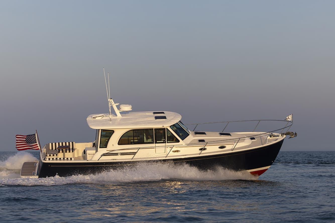 2026 Back Cove 412 yacht cruising on open water at sunset.