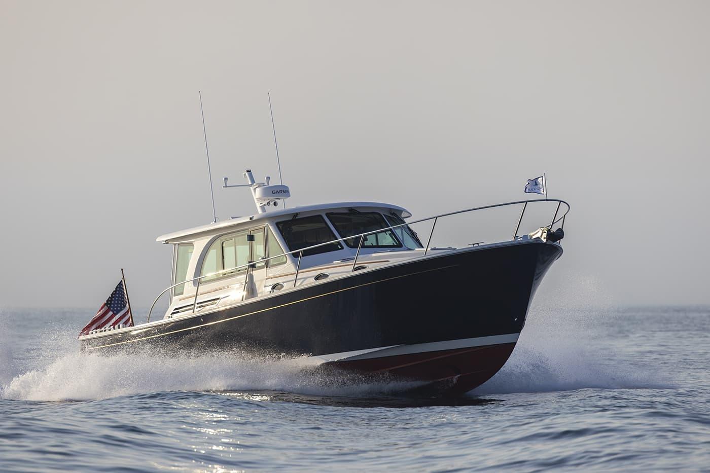 2026 Back Cove 412 yacht cruising on open water with American flag.
