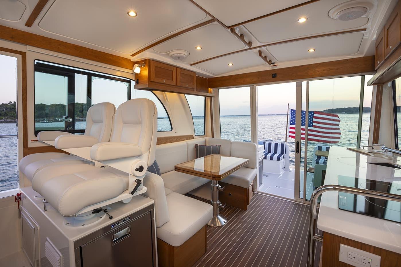 Luxurious interior of 2026 Back Cove 412 yacht with ocean view and American flag.