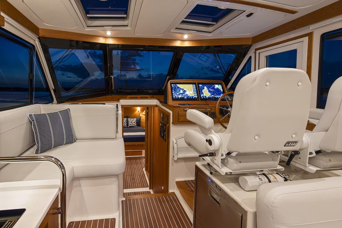 Luxurious interior of 2026 Back Cove 412 yacht with plush seating and advanced navigation displays.