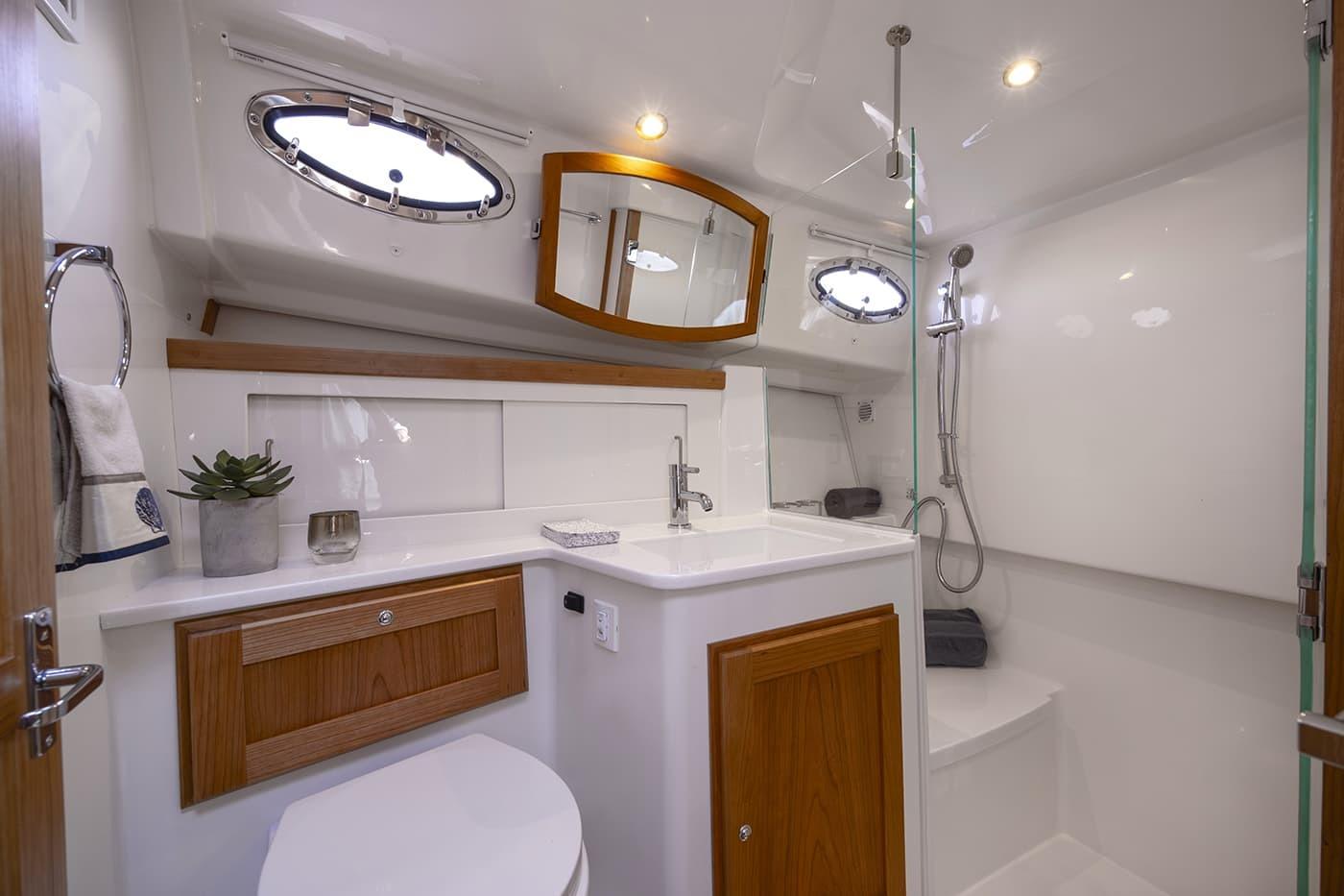 Luxurious bathroom in 2026 Back Cove 412 yacht with modern fixtures and wood accents.