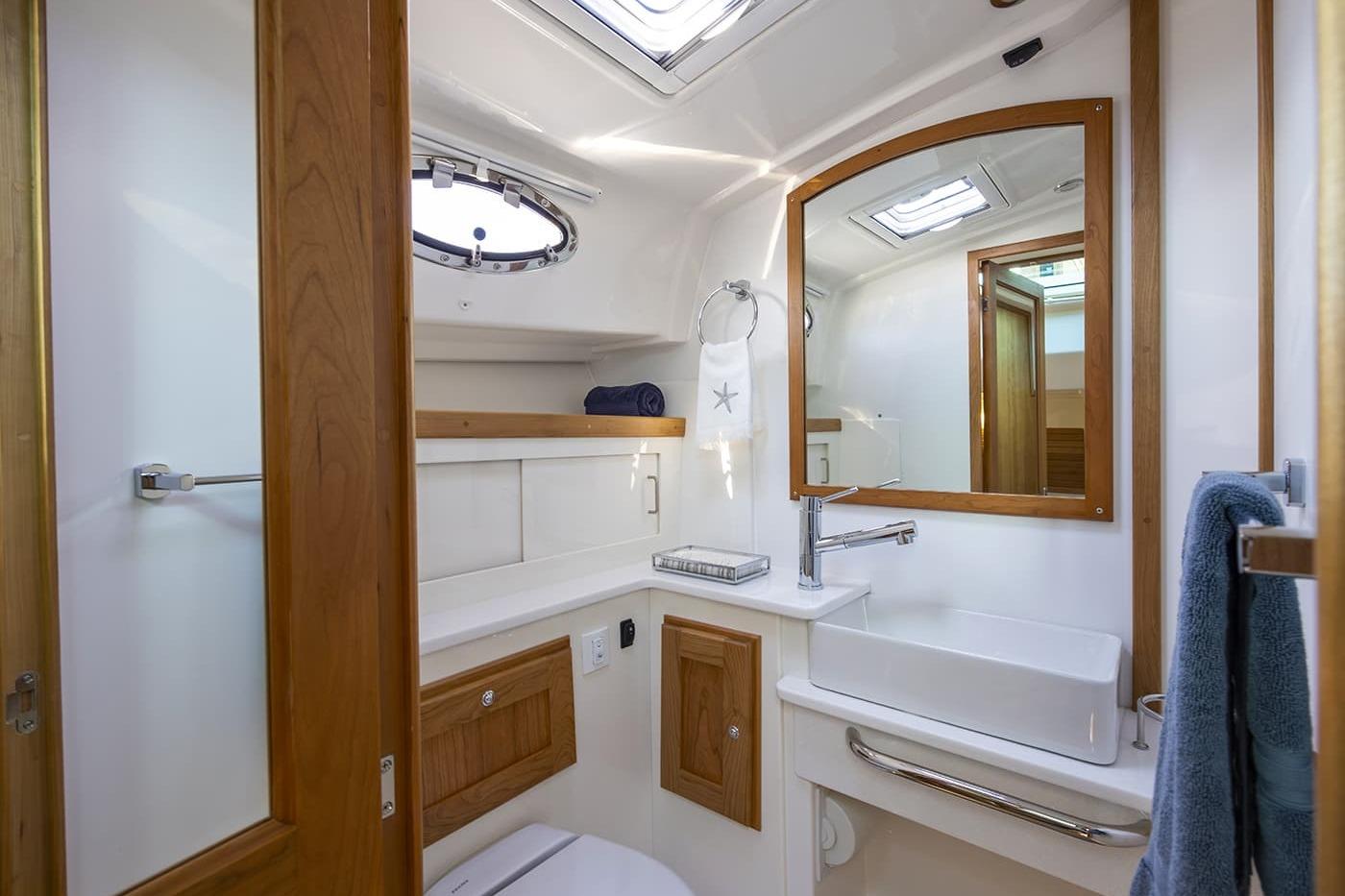 Luxurious bathroom in 2026 Back Cove 412 yacht with modern fixtures and wooden accents.