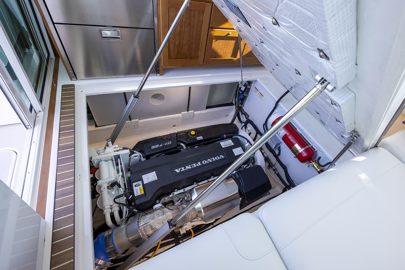 2026 Back Cove 412 engine compartment with Volvo Penta engine and fire extinguisher.