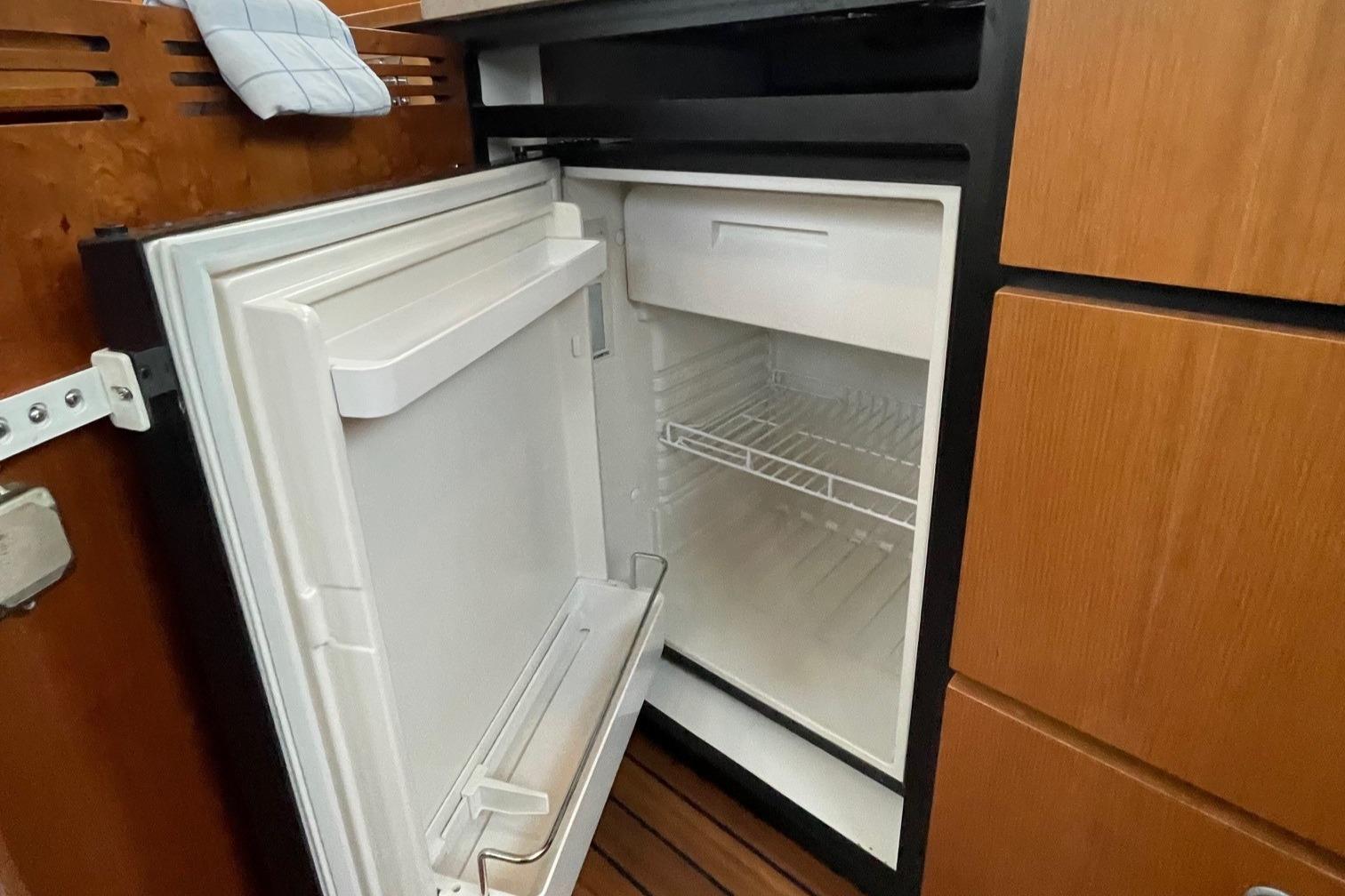 Open refrigerator inside a 2012 Linssen 36.9 boat, showcasing interior shelving.