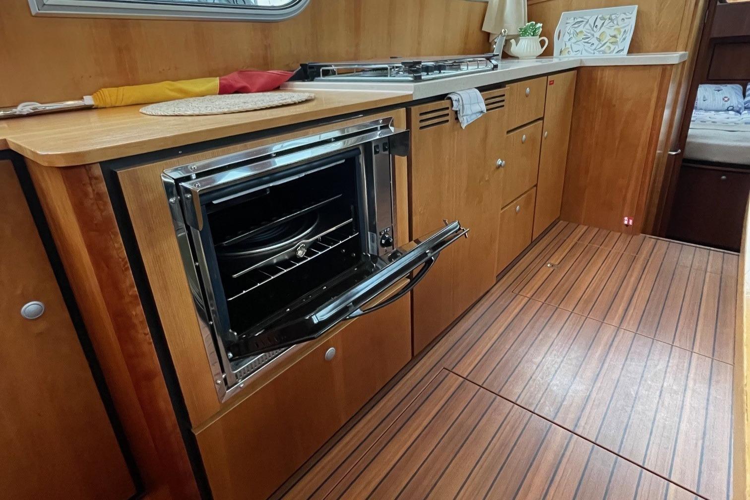 Linssen 36.9 yacht kitchen interior with wood finish and open oven, 2012 model.