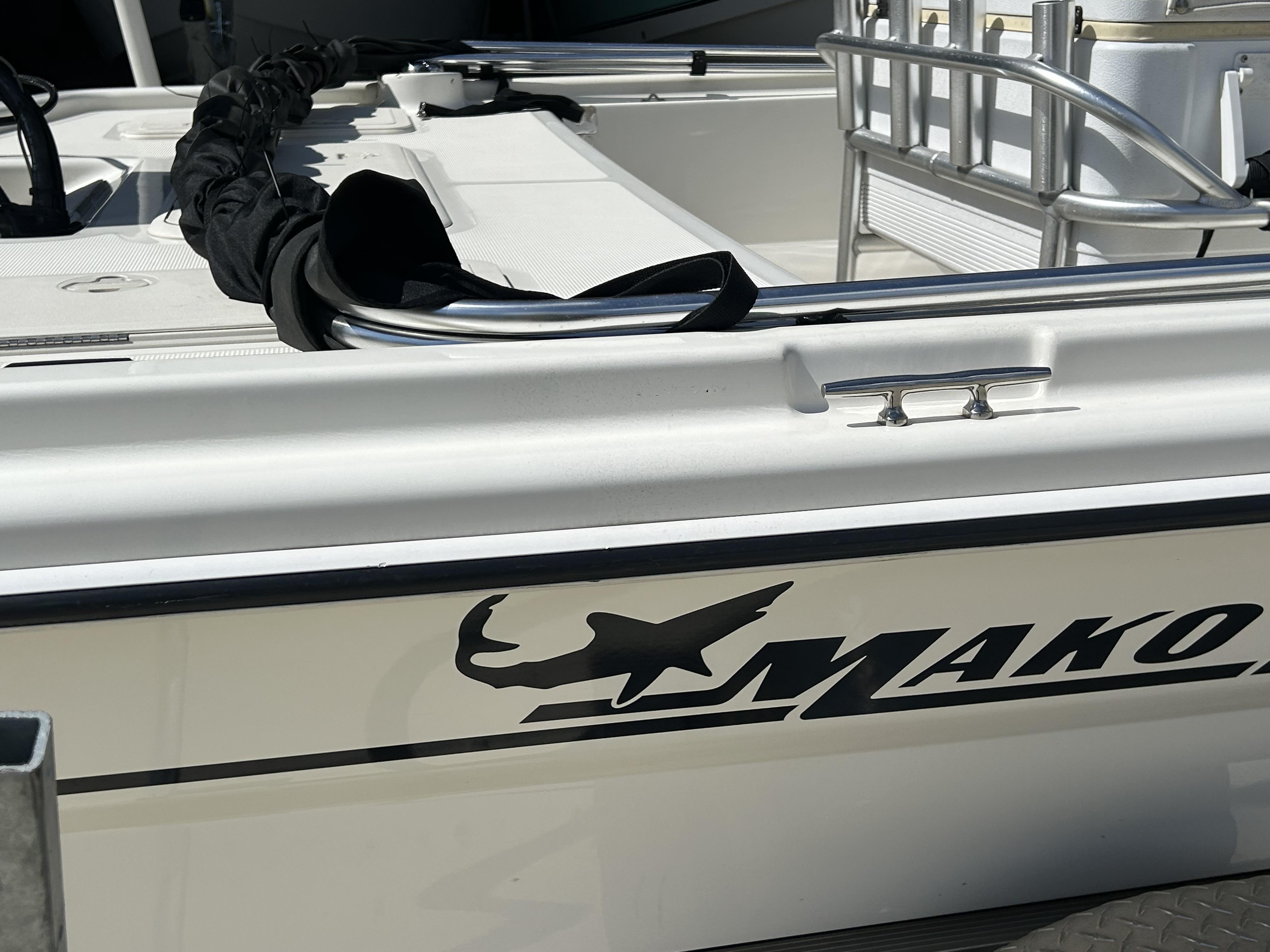2021 Mako Pro Skiff 19 CC boat, white exterior with logo, docked.