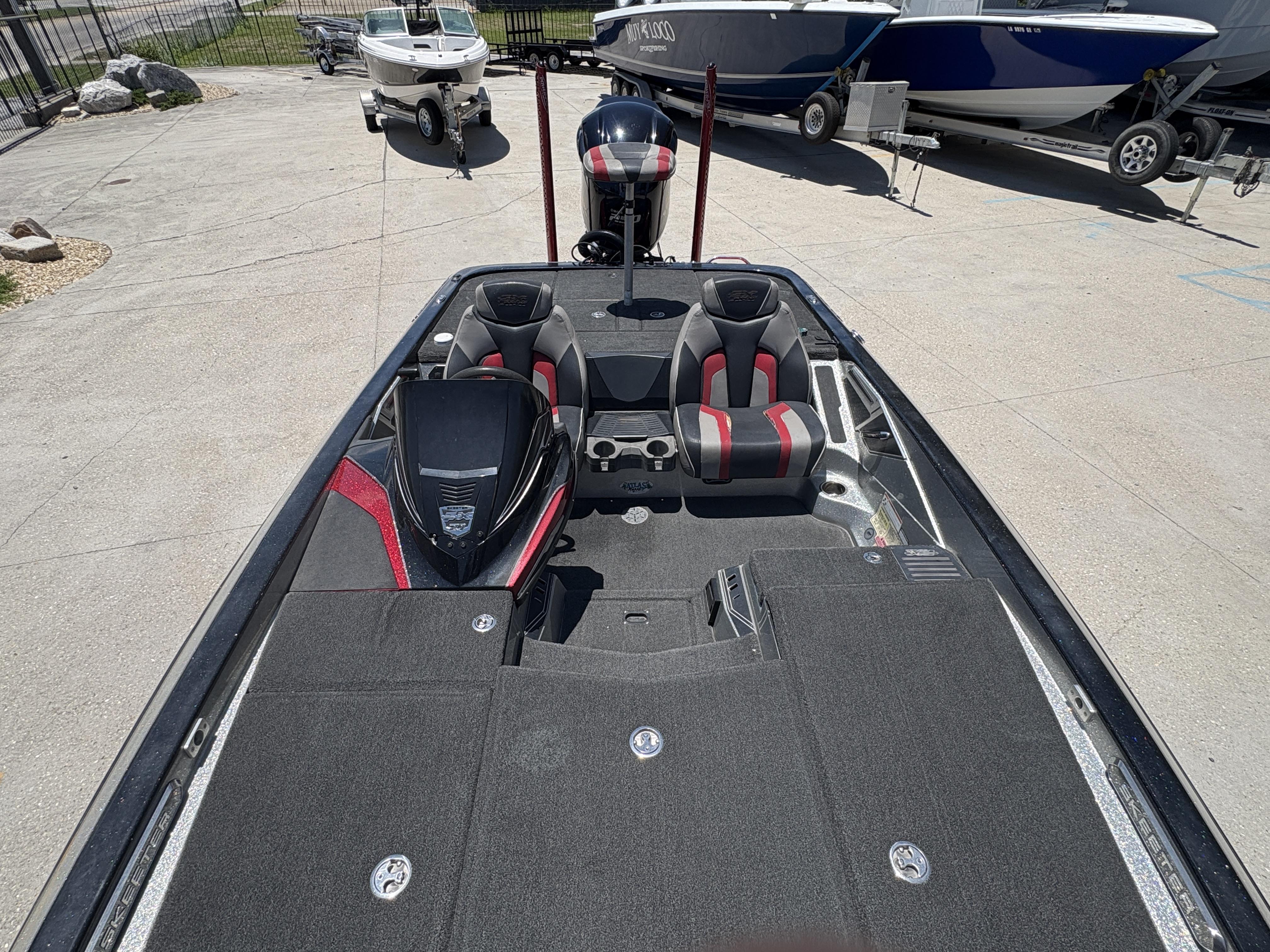 2018 Skeeter FX 21 bass boat with dual seats and storage compartments, parked outdoors.