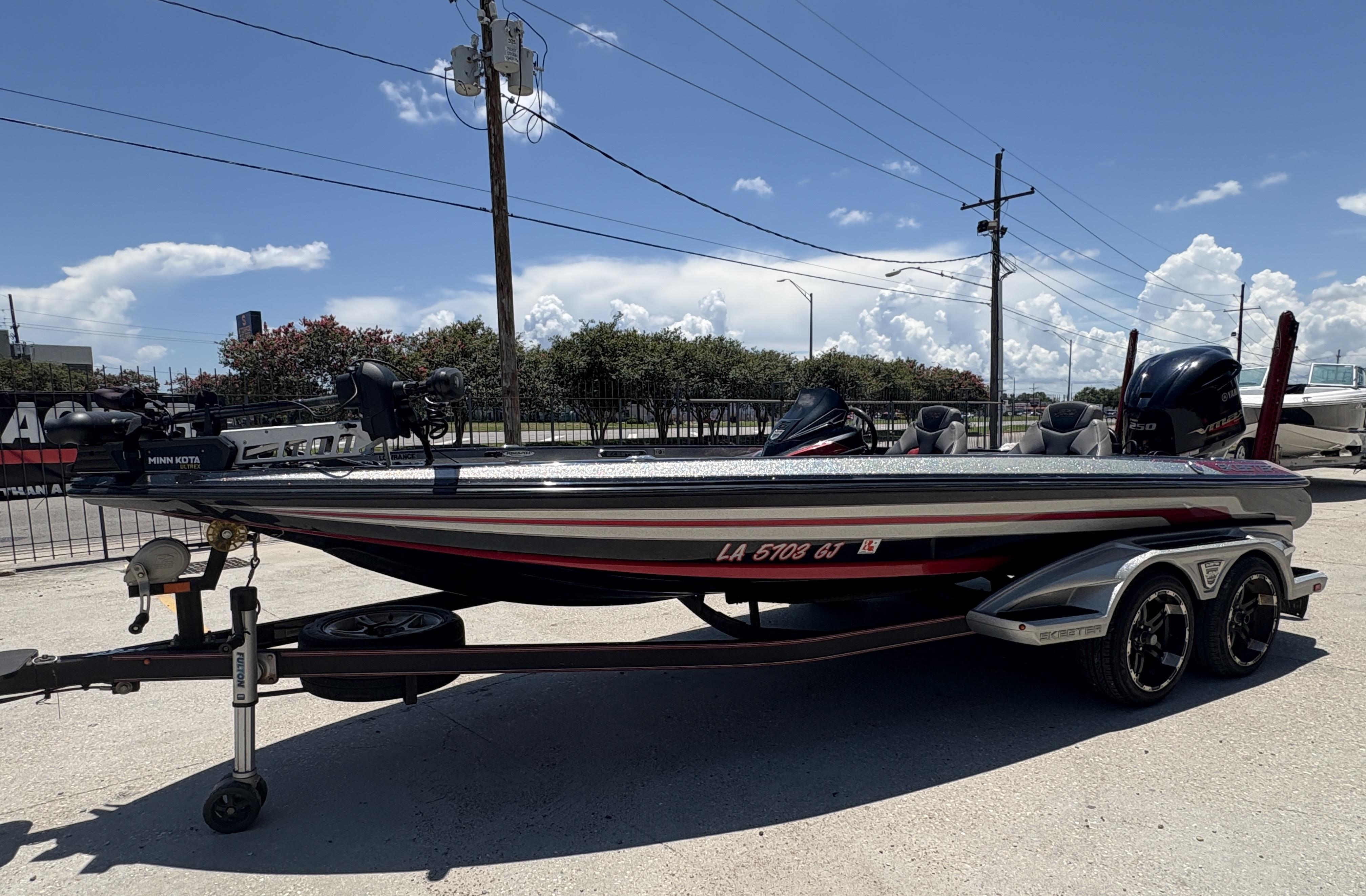 2018 Skeeter FX 21 boat on trailer under clear blue sky.
